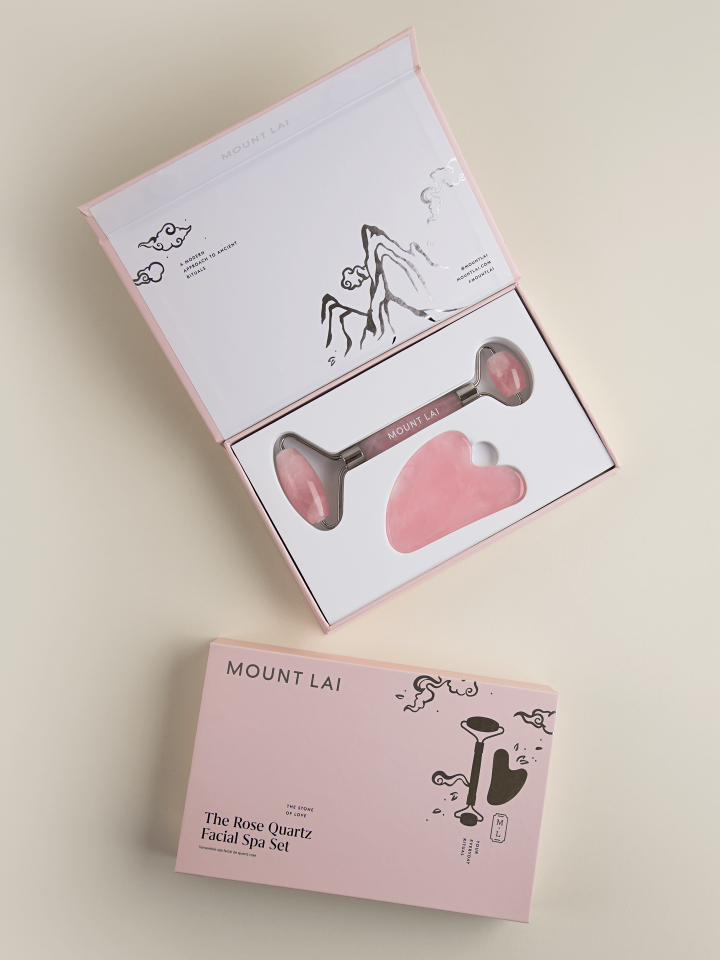 Rose quartz gua sha lifting tool and facial roller in open pink gift box