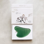Firm, lift, and contour the skin with the Mount Lai Jade Gua Sha Facial Lifting Tool.