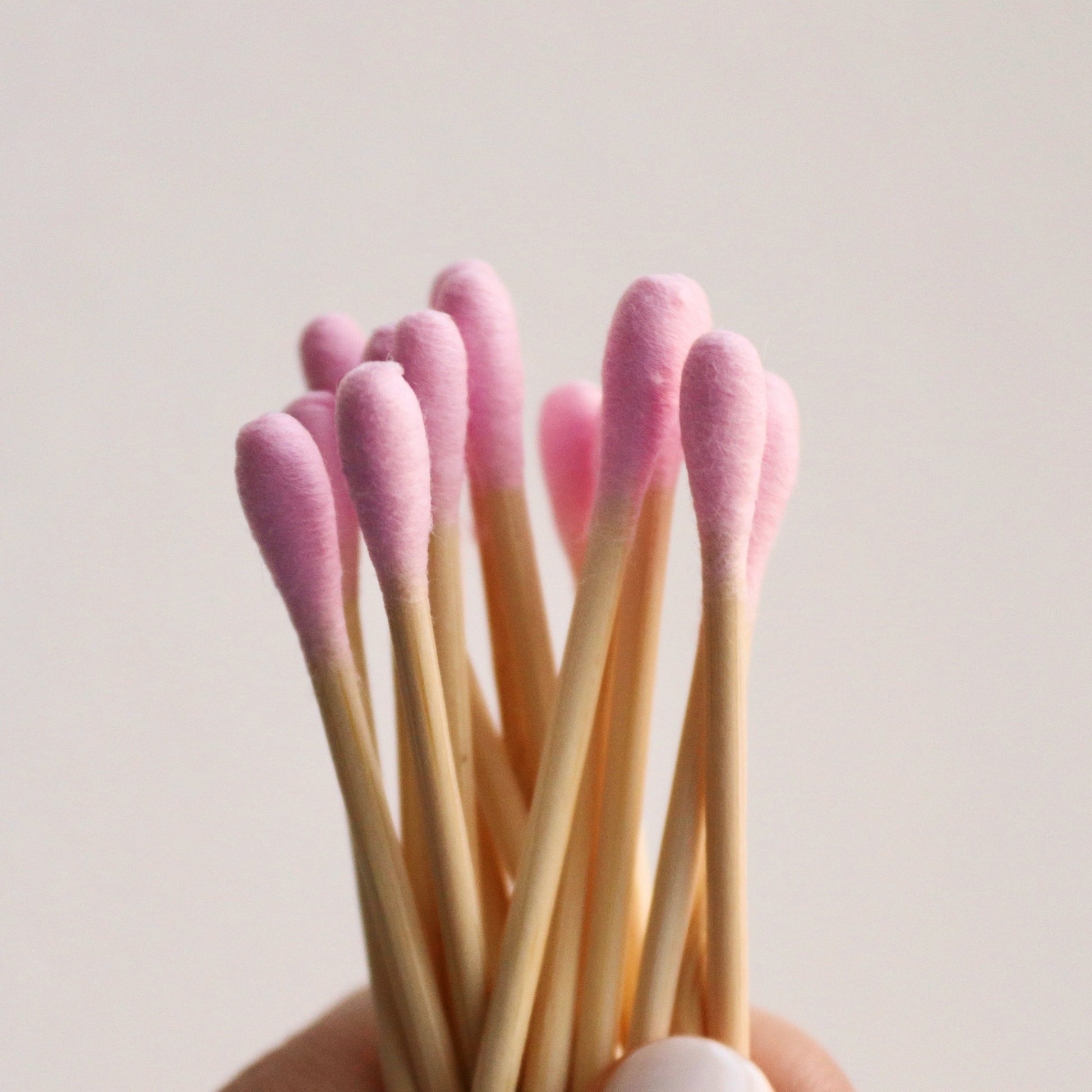 Holding up mei apothecary pink bamboo swaps with pink tips
